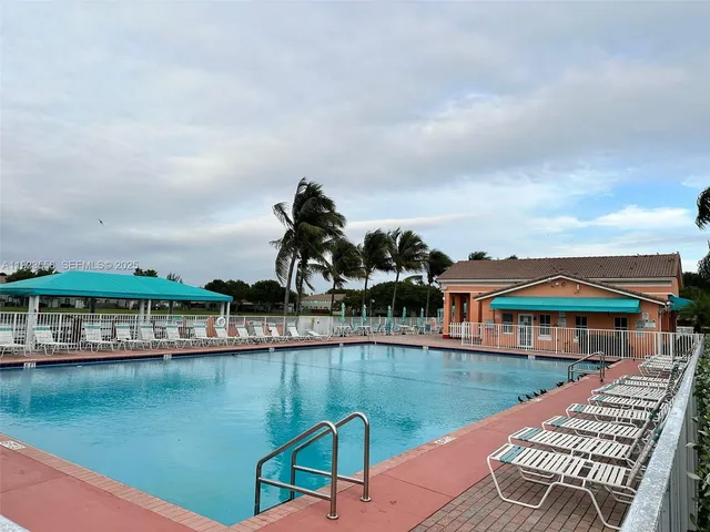 a view of a swimming pool with a yard