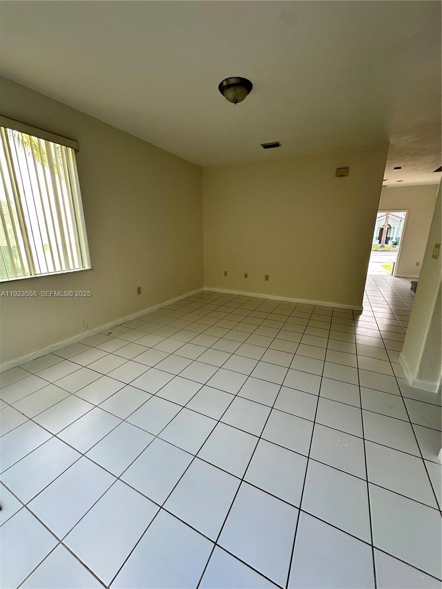 1529 Southeast 24th Court, Unit 233 Homestead, FL 33035 - Photo 4 of 35 a view of an empty room and a window