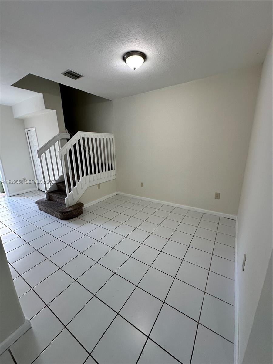 1529 Southeast 24th Court, Unit 233 Homestead, FL 33035 - Photo 5 of 35 a view of an empty room and wooden floor