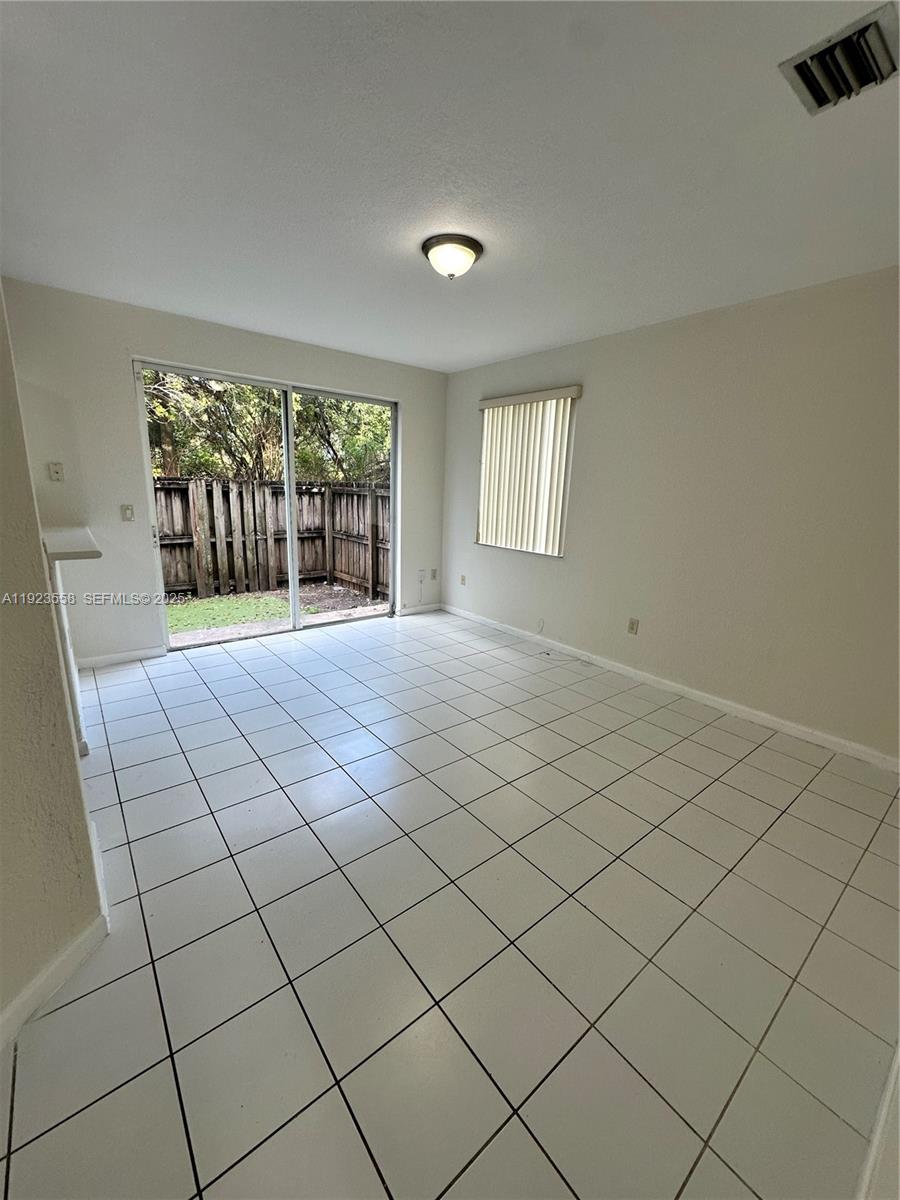 1529 Southeast 24th Court, Unit 233 Homestead, FL 33035 - Photo 6 of 35 a view of an empty room and window