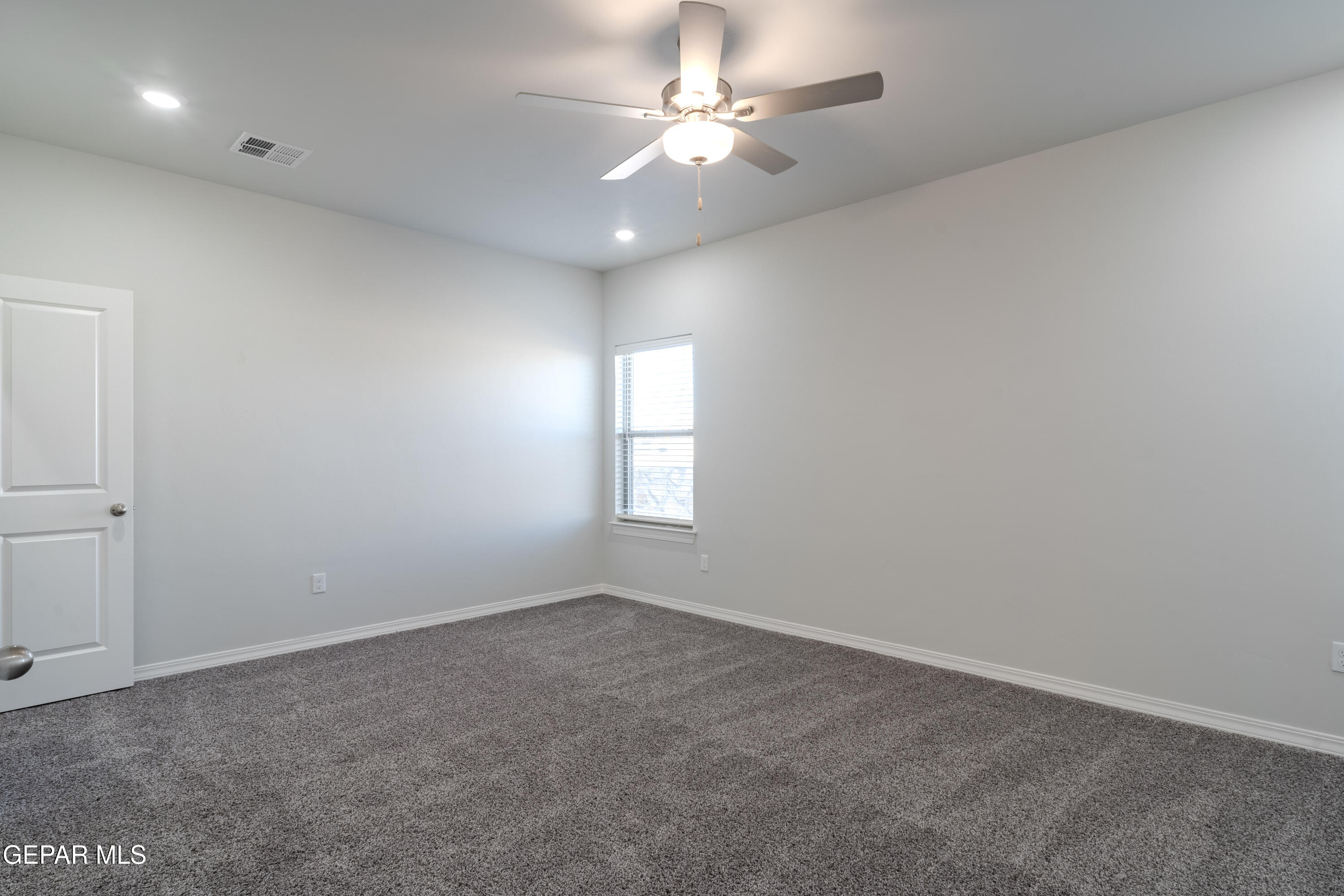 985 Barbara Avenue Socorro, TX 79927 - Photo 13 of 29 wooden floor in an empty room with a window