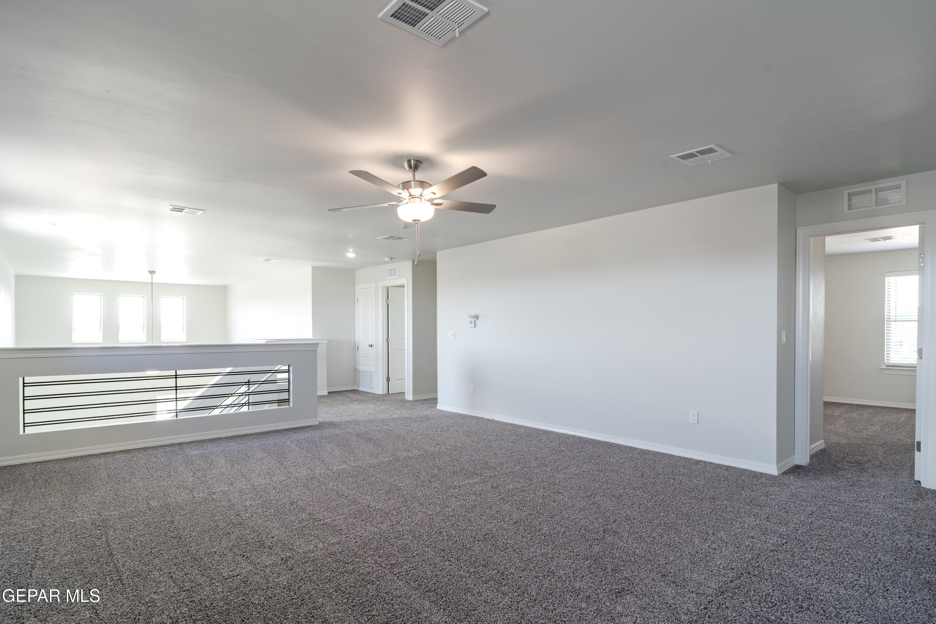 985 Barbara Avenue Socorro, TX 79927 - Photo 18 of 29 a view of an empty room with a chandelier fan
