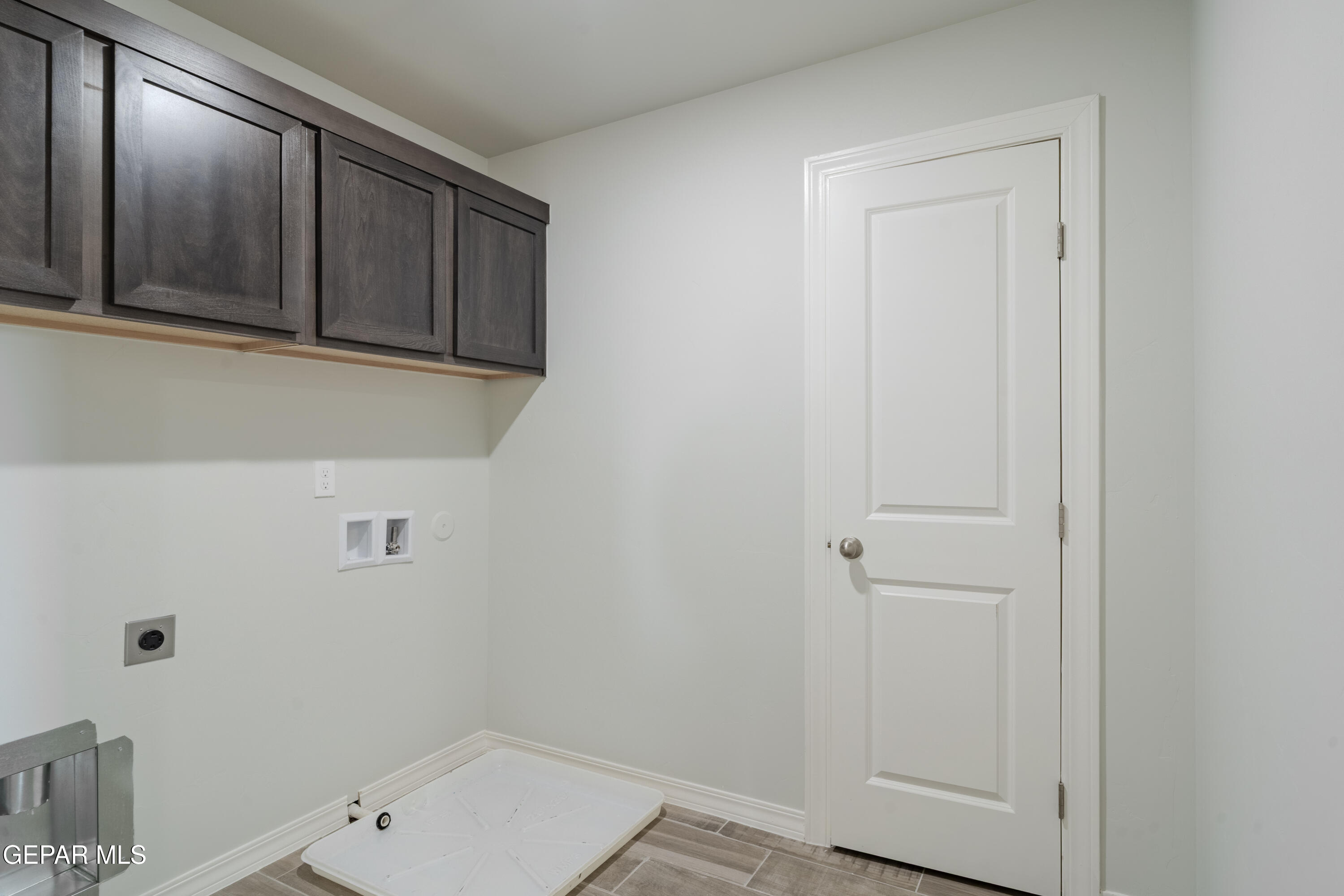 985 Barbara Avenue Socorro, TX 79927 - Photo 19 of 29 a bathroom with a sink and cabinets