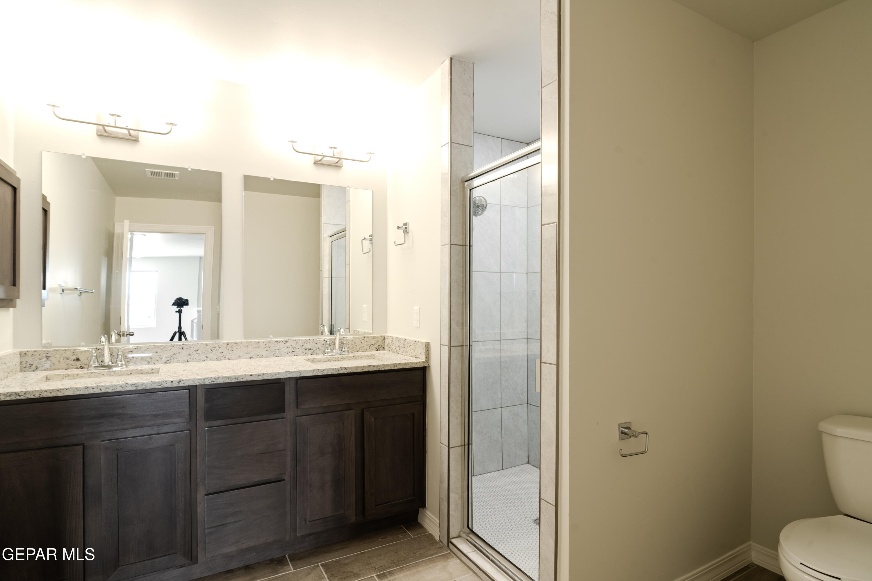 985 Barbara Avenue Socorro, TX 79927 - Photo 20 of 29 a bathroom with a granite countertop sink toilet and shower