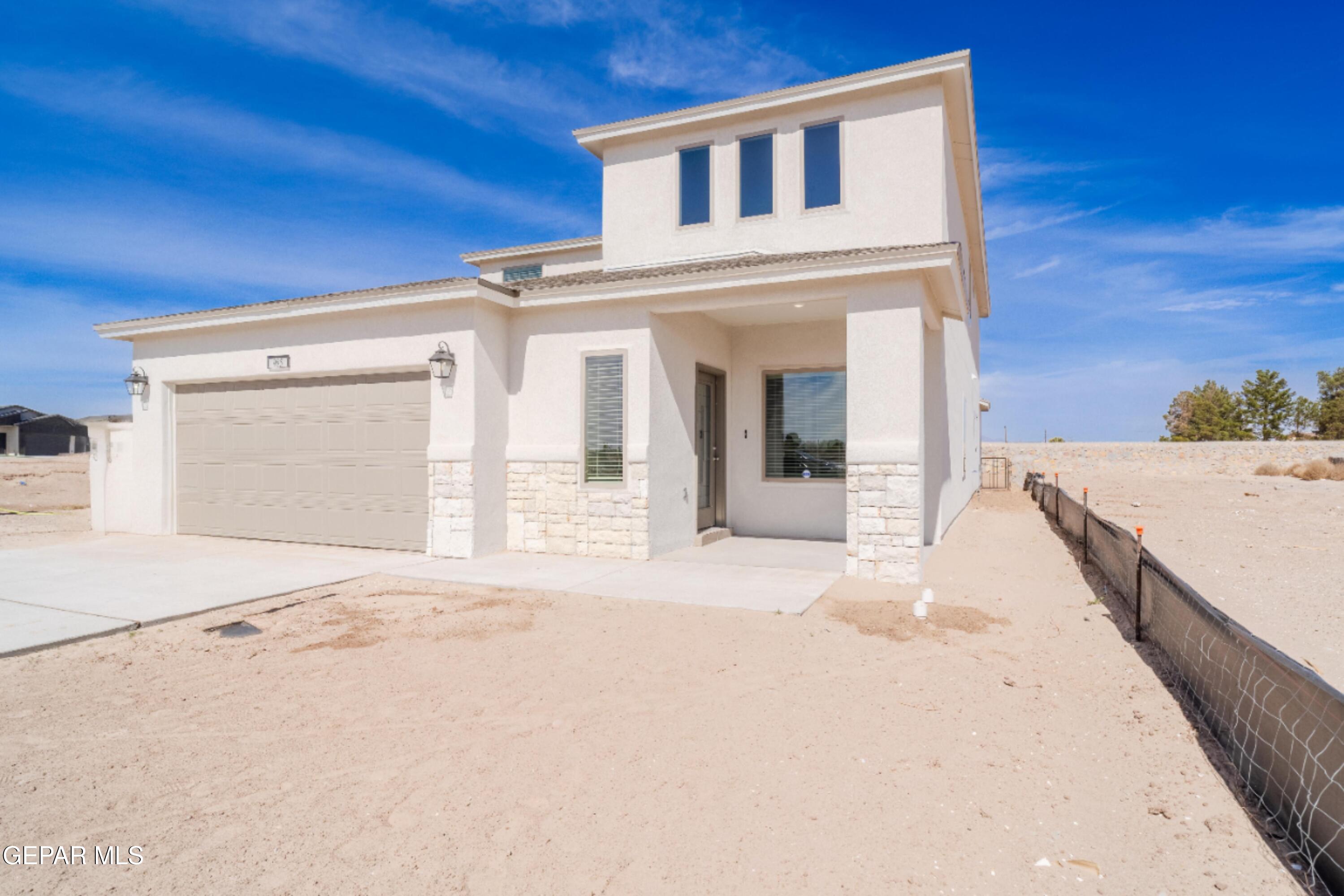 985 Barbara Avenue Socorro, TX 79927 - Photo 2 of 29 a view of a white house with a outdoor space