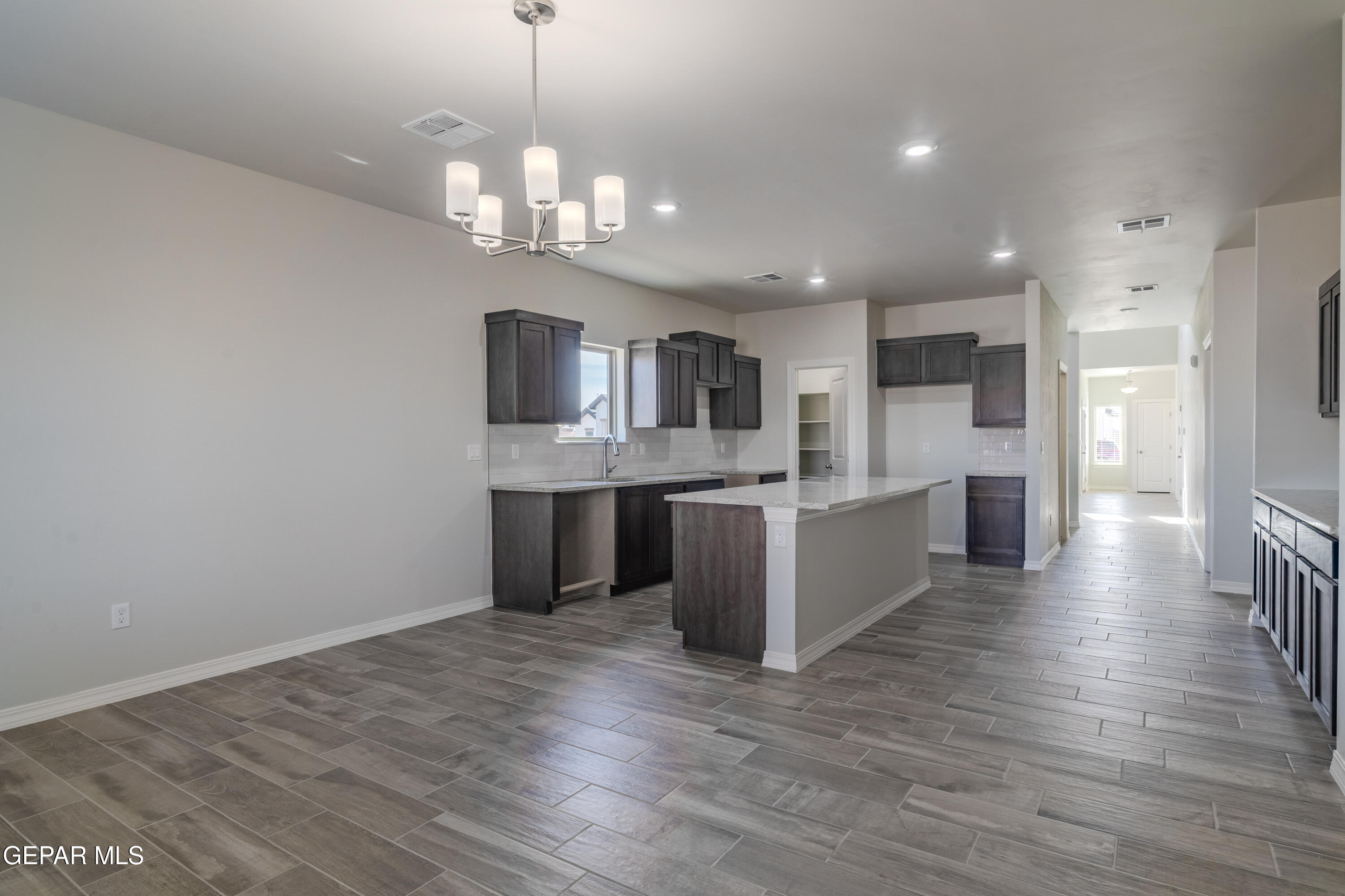 985 Barbara Avenue Socorro, TX 79927 - Photo 6 of 29 a large kitchen with granite countertop a large counter top space appliances and cabinets