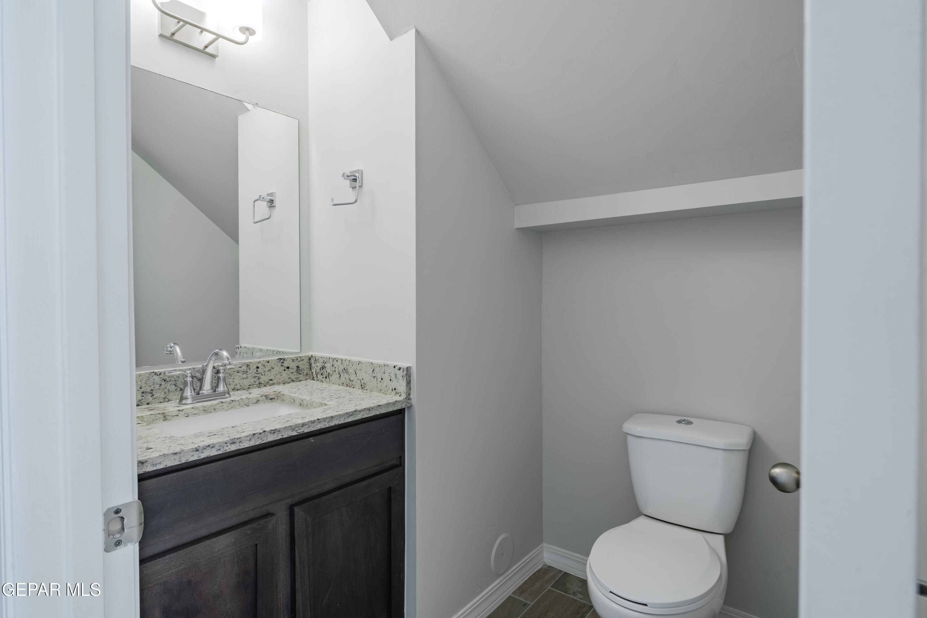 985 Barbara Avenue Socorro, TX 79927 - Photo 8 of 29 a bathroom with a granite countertop toilet and a sink