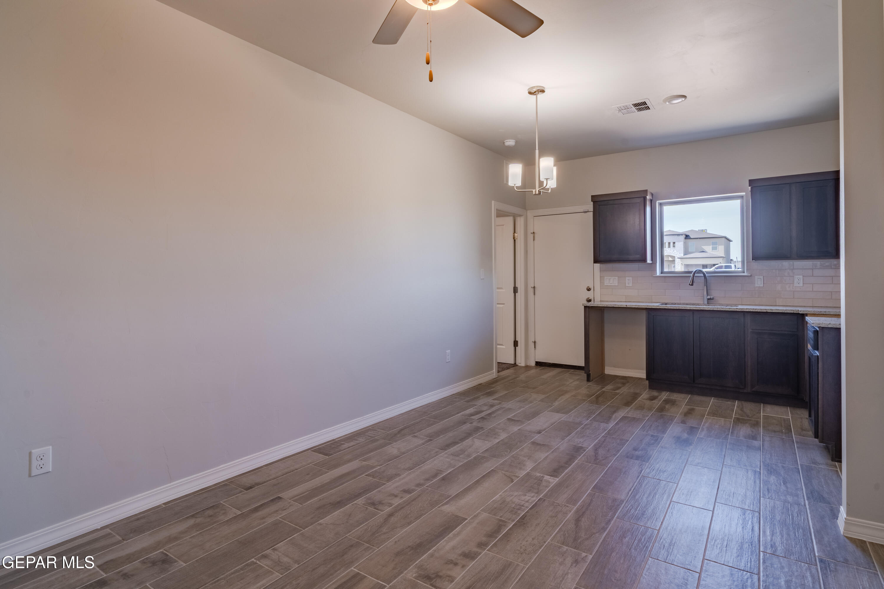 985 Barbara Avenue Socorro, TX 79927 - Photo 9 of 29 wooden floor in an empty room with a window