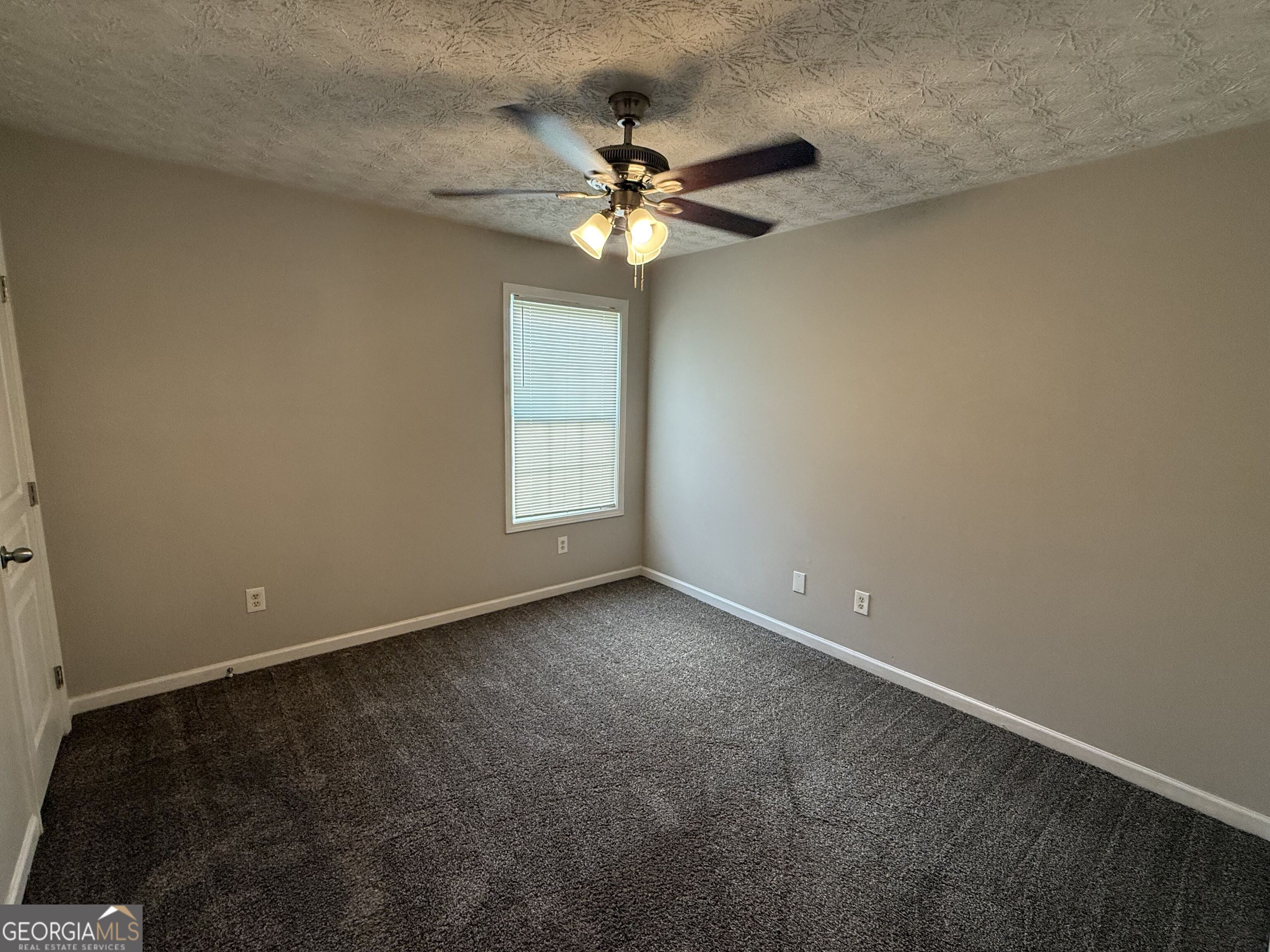 6132 Ruth Street Southwest Covington, GA 30014 - Photo 17 of 33 an empty room with a window and a fan