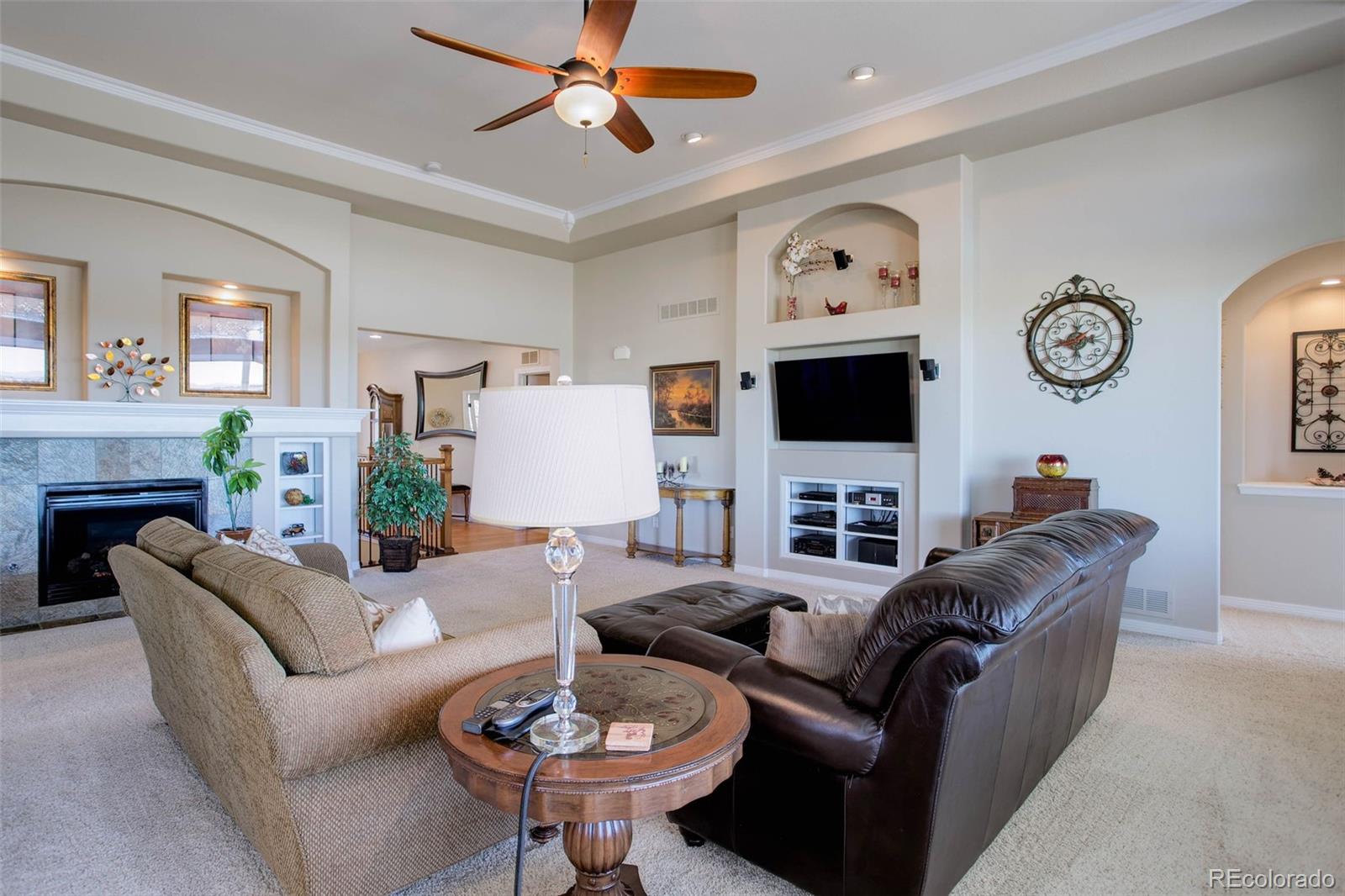 3441 Antelope Ridge Trail Parker, CO 80138 - Photo 12 of 50 a living room with furniture a clock and a window