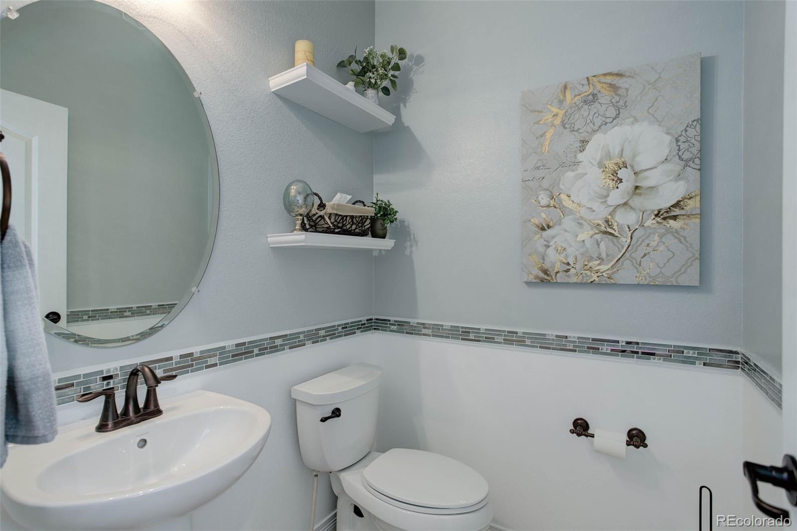 3441 Antelope Ridge Trail Parker, CO 80138 - Photo 21 of 50 a bathroom with a toilet sink and mirror