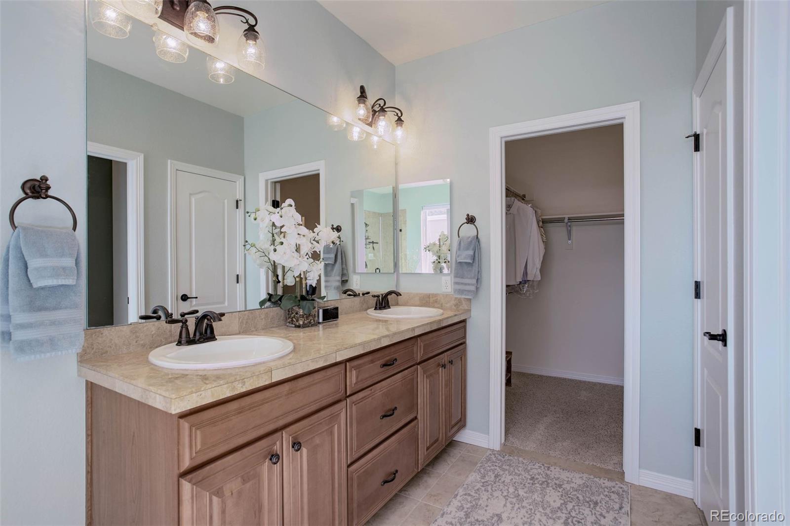 3441 Antelope Ridge Trail Parker, CO 80138 - Photo 26 of 50 a bathroom with double sink and a mirror