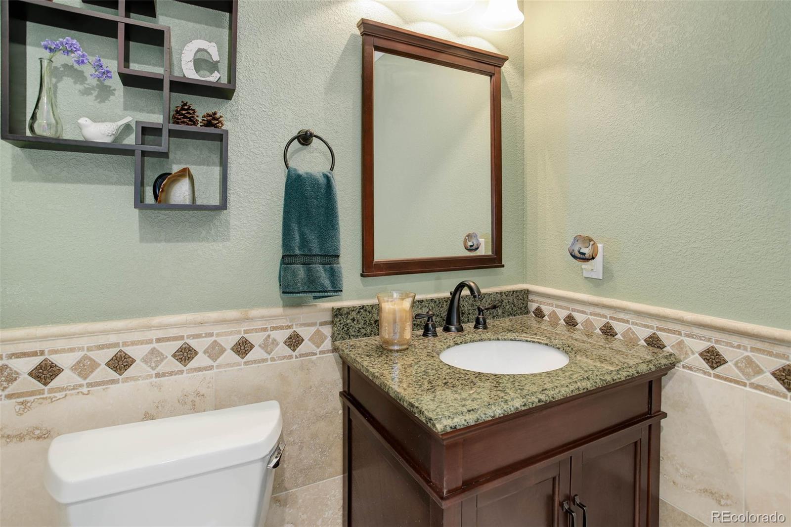 3441 Antelope Ridge Trail Parker, CO 80138 - Photo 33 of 50 a bathroom with a granite countertop sink and a mirror
