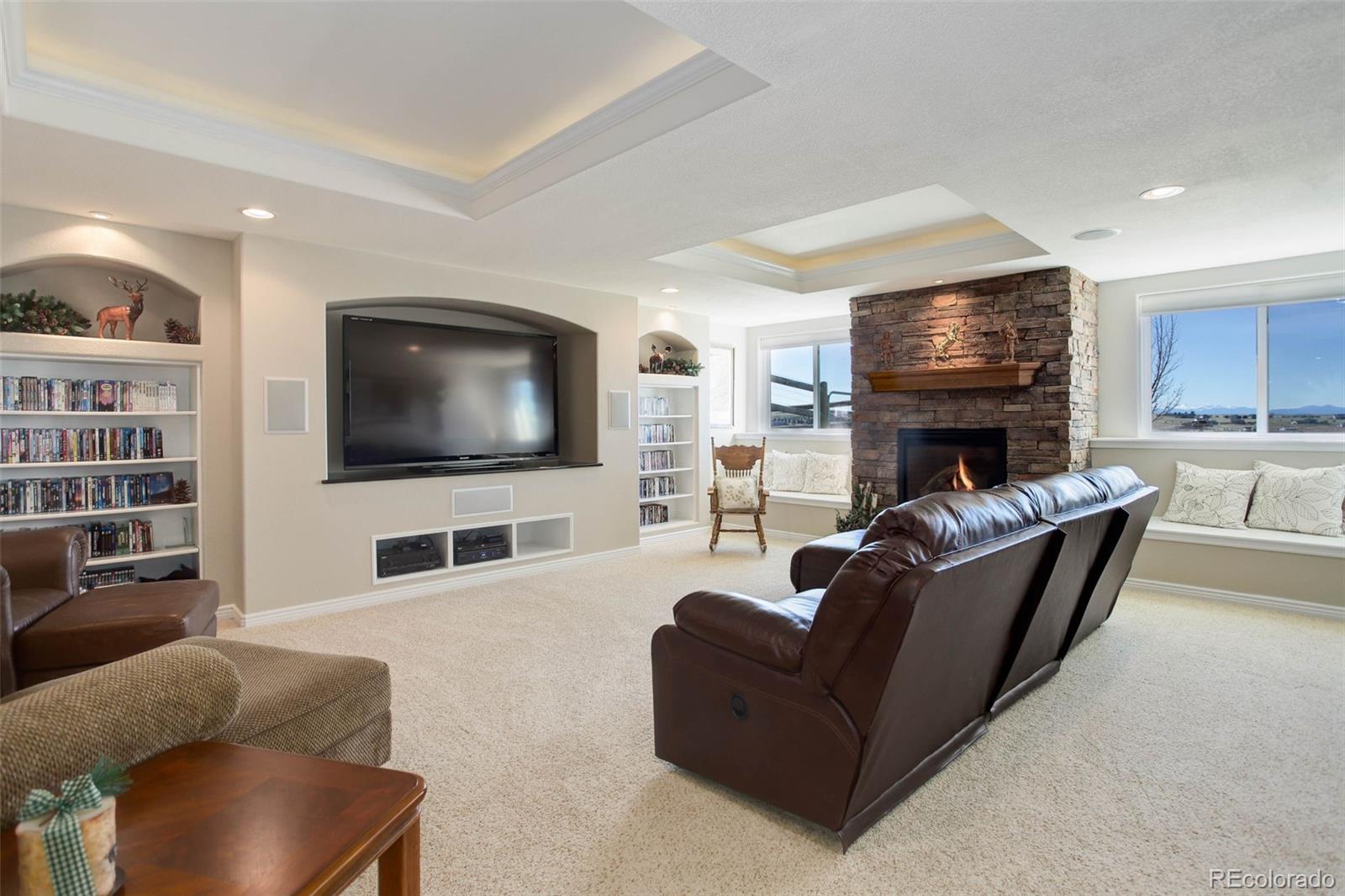 3441 Antelope Ridge Trail Parker, CO 80138 - Photo 37 of 50 a living room with furniture and a flat screen tv
