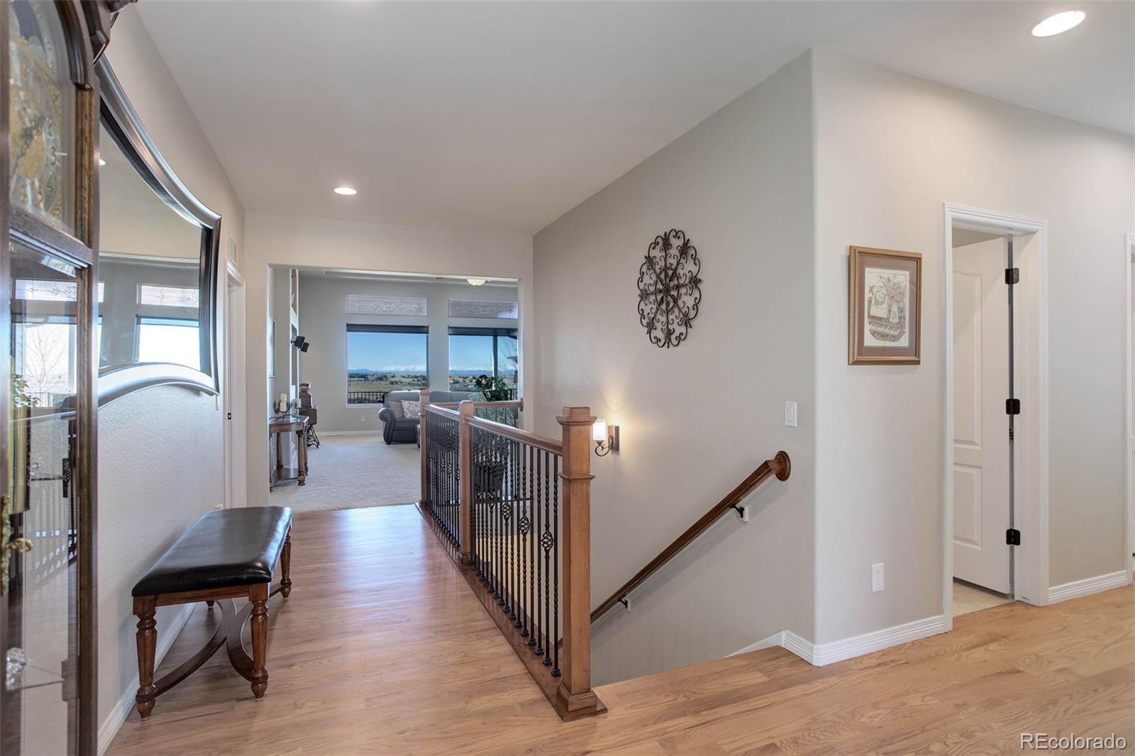 3441 Antelope Ridge Trail Parker, CO 80138 - Photo 9 of 50 a view of a hallway with a dining table and chairs