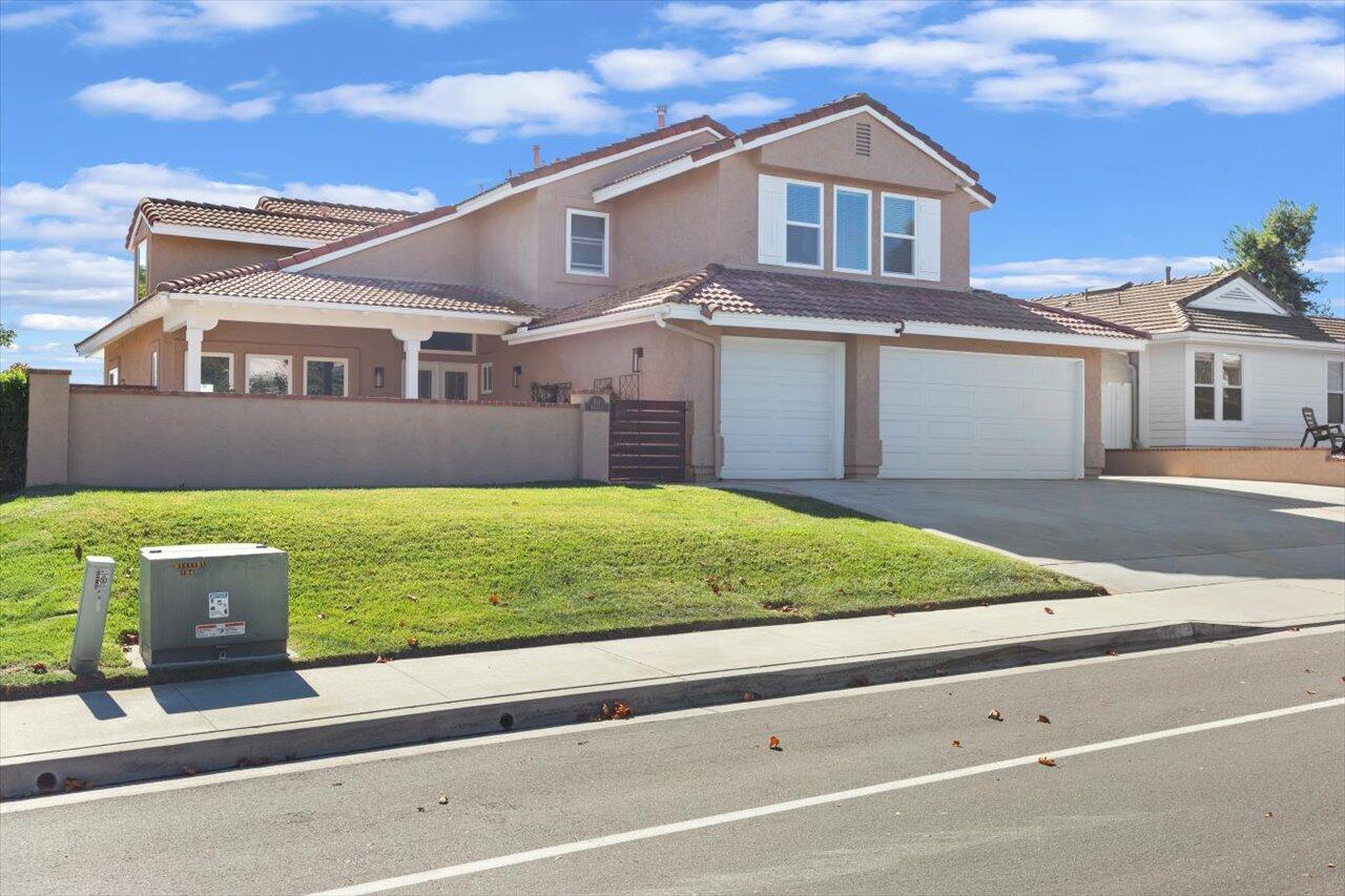 911 Rivertree Drive Oceanside, CA 92058 - Photo 2 of 43 a front view of a house with a garden and yard