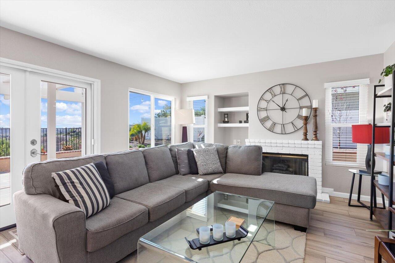 911 Rivertree Drive Oceanside, CA 92058 - Photo 11 of 43 a living room with furniture a fireplace and a window