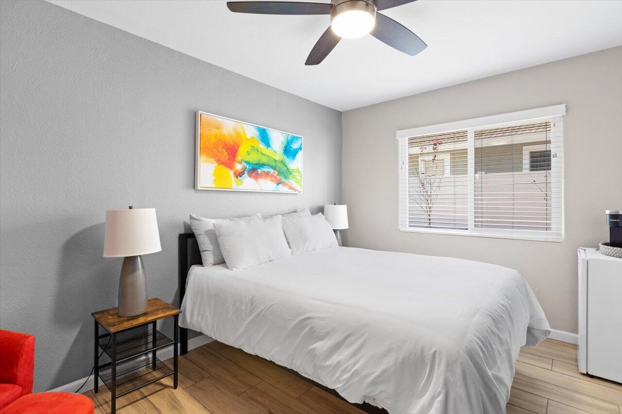 911 Rivertree Drive Oceanside, CA 92058 - Photo 12 of 43 a bedroom with a bed and a painting on the wall