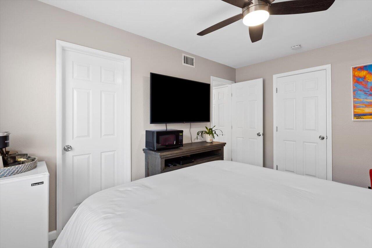 911 Rivertree Drive Oceanside, CA 92058 - Photo 13 of 43 a bedroom with a bed and a flat screen tv