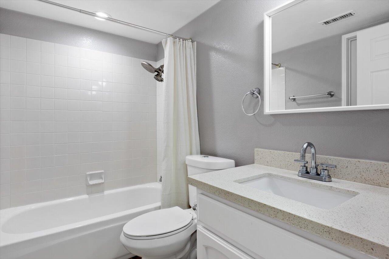 911 Rivertree Drive Oceanside, CA 92058 - Photo 14 of 43 a bathroom with a granite countertop sink toilet and shower
