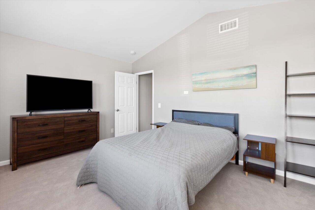911 Rivertree Drive Oceanside, CA 92058 - Photo 17 of 43 a bedroom with a bed and a flat screen tv