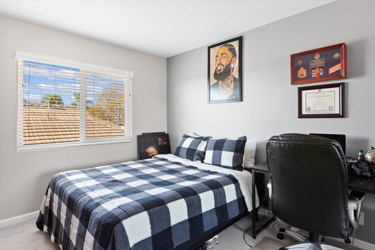 911 Rivertree Drive Oceanside, CA 92058 - Photo 18 of 43 a bedroom with a bed and a window