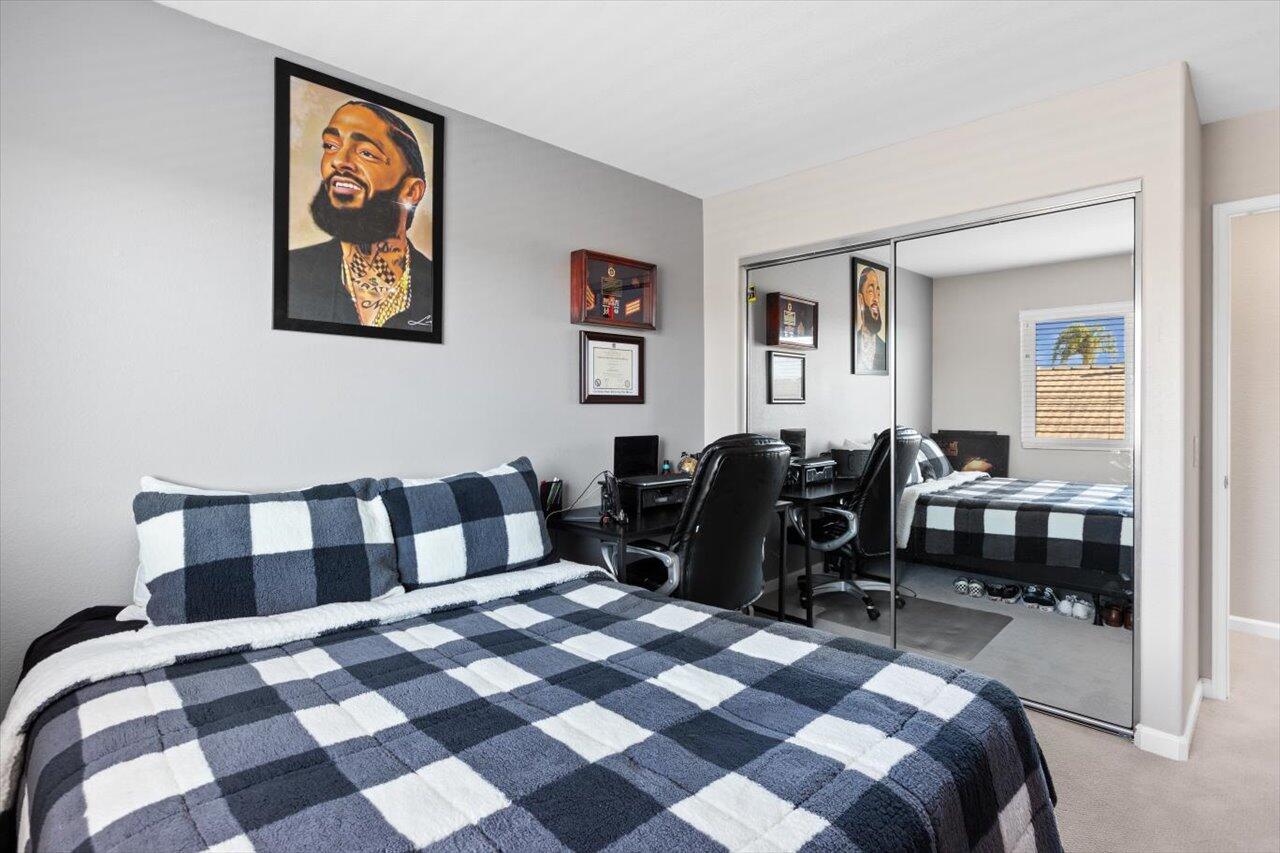 911 Rivertree Drive Oceanside, CA 92058 - Photo 19 of 43 a living room with a black white checkered floor with couches chair and a coffee table