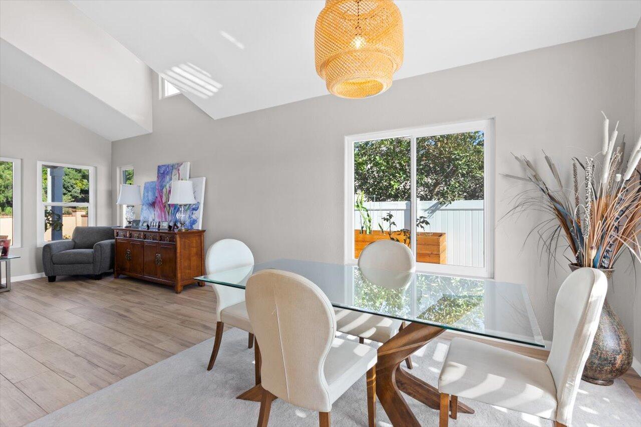 911 Rivertree Drive Oceanside, CA 92058 - Photo 22 of 43 a view of a dining room with furniture and a large window