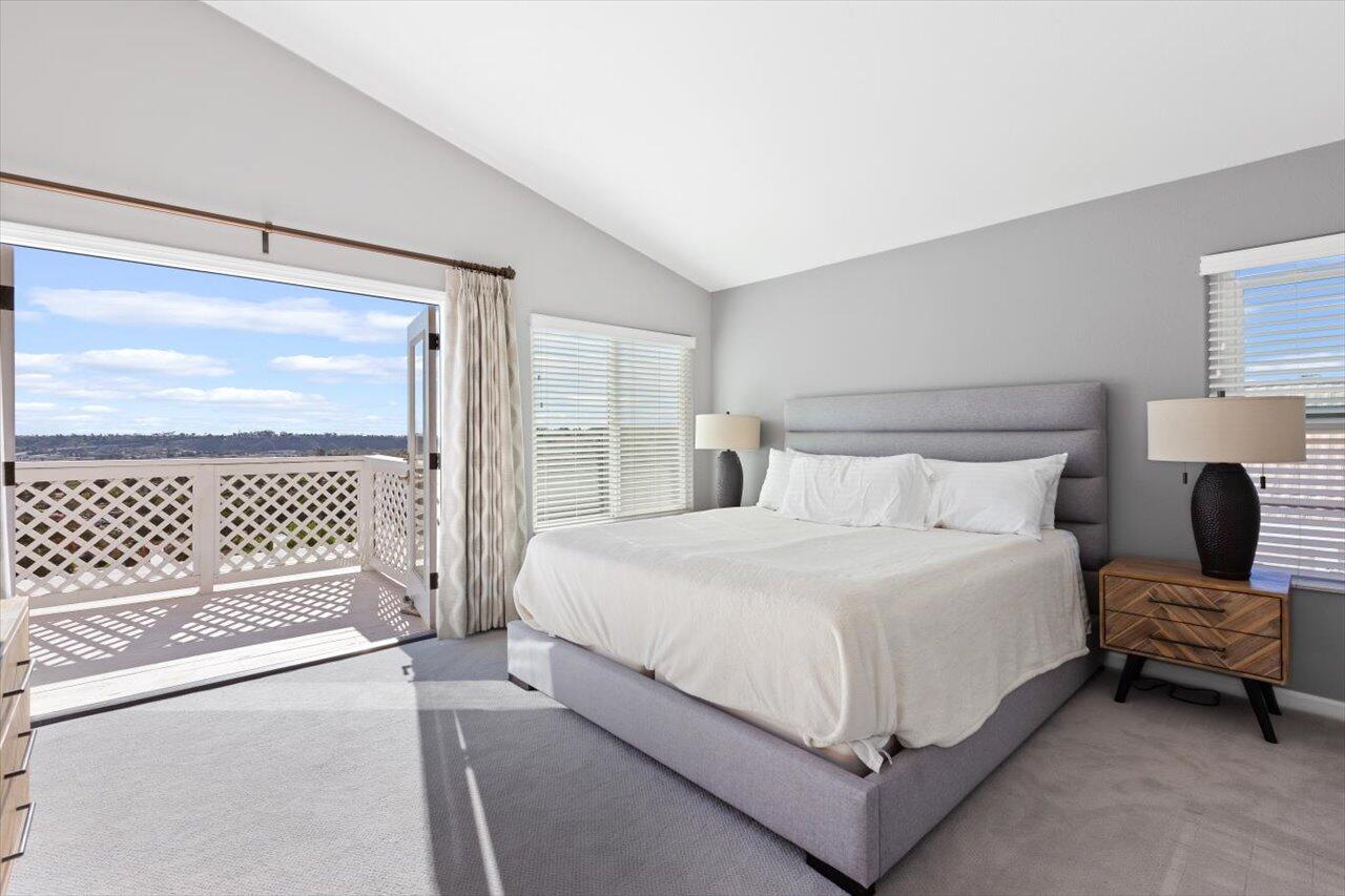 911 Rivertree Drive Oceanside, CA 92058 - Photo 23 of 43 a bedroom with a bed and a lamp with table