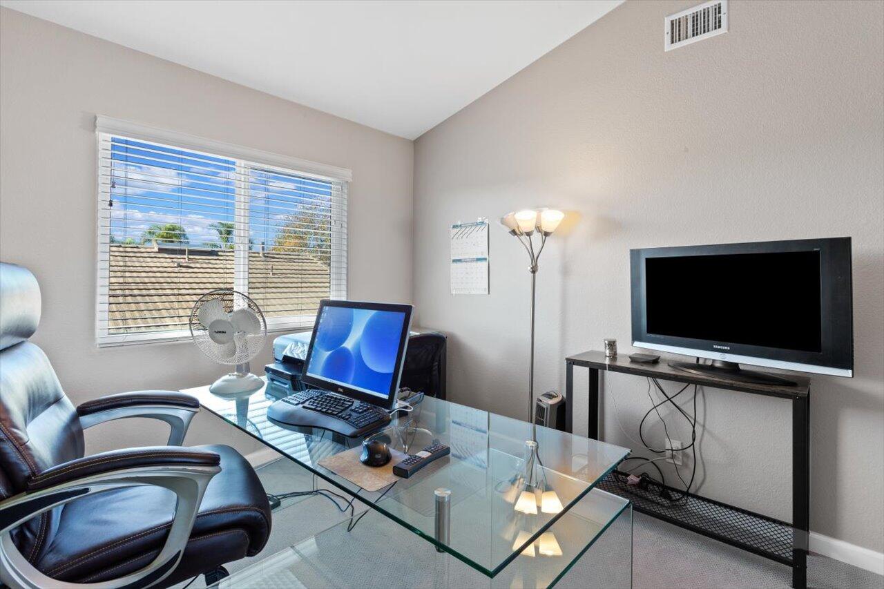 911 Rivertree Drive Oceanside, CA 92058 - Photo 27 of 43 a living room with furniture and a flat screen tv