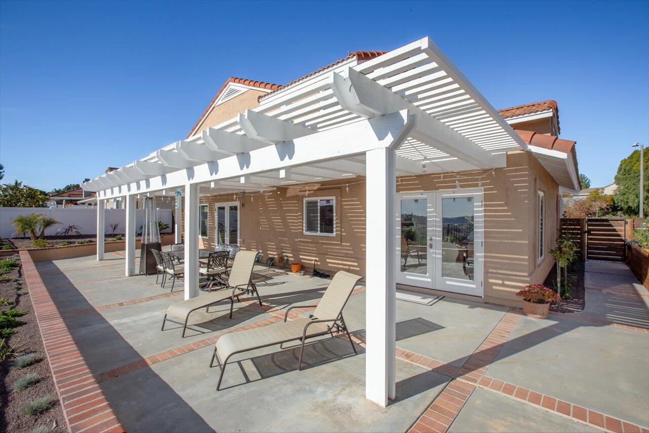 911 Rivertree Drive Oceanside, CA 92058 - Photo 30 of 43 a view of a house with backyard porch and sitting area