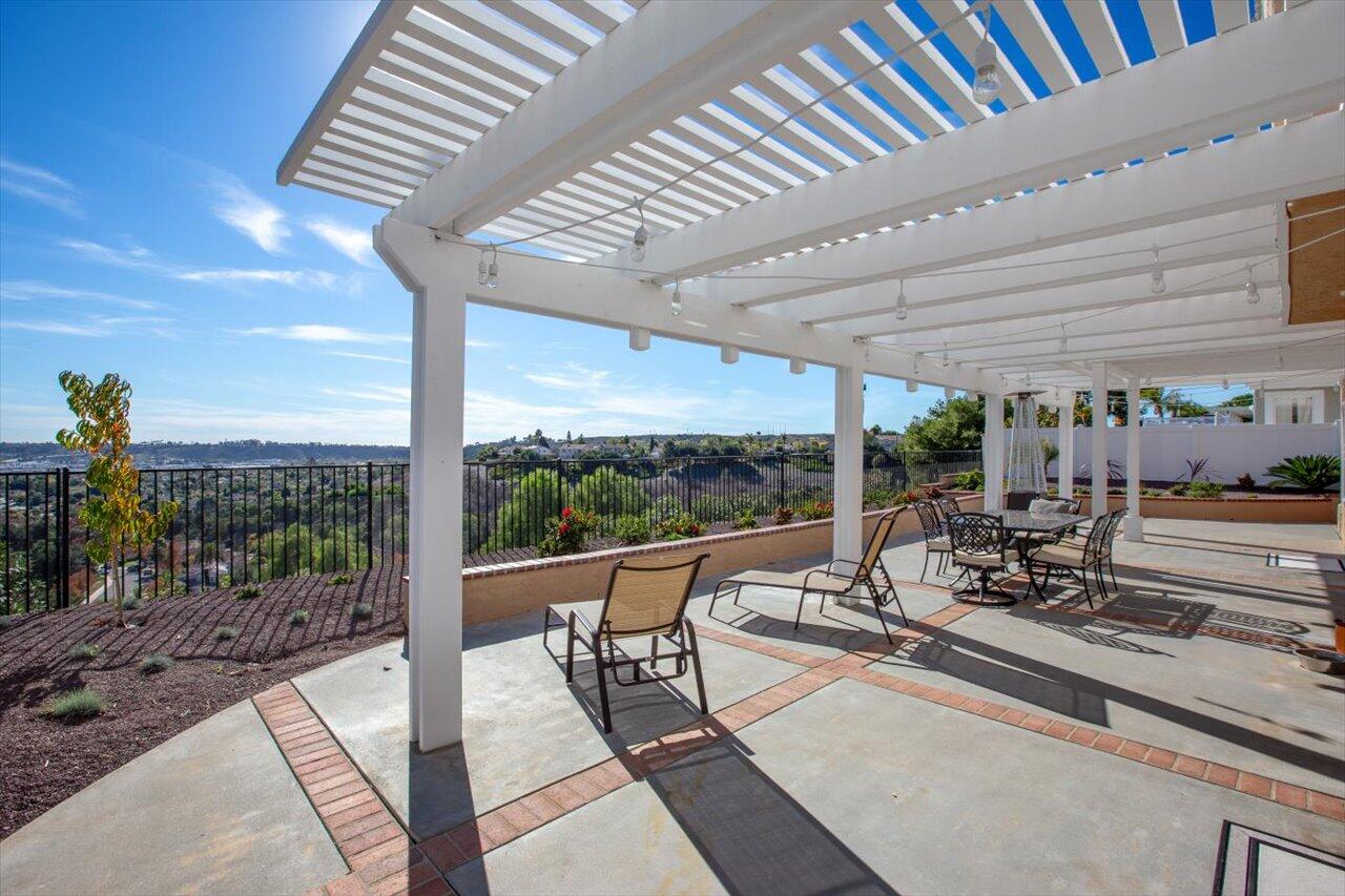 911 Rivertree Drive Oceanside, CA 92058 - Photo 31 of 43 a view of a patio with a dining table and chairs with wooden floor