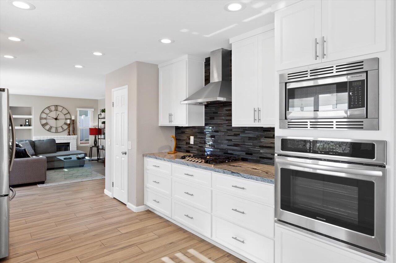 911 Rivertree Drive Oceanside, CA 92058 - Photo 8 of 43 a kitchen with stainless steel appliances granite countertop a stove top oven and cabinets