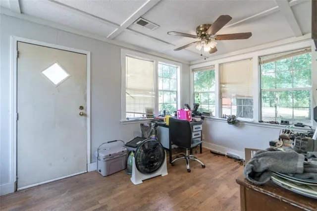 a view of a workspace with furniture and a window