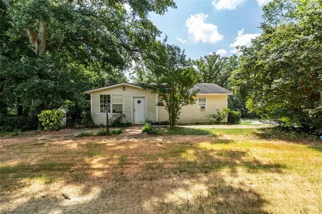 a view of a house with a tree in the background