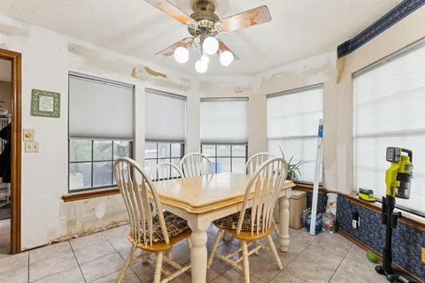 a living room with furniture a flat screen tv and a window