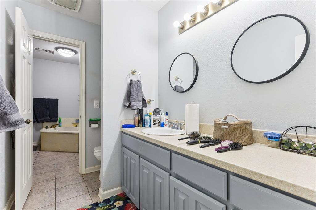202 Blue Mound Road East Haslet, TX 76052 - Photo 19 of 31 a bathroom with a sink and a mirror