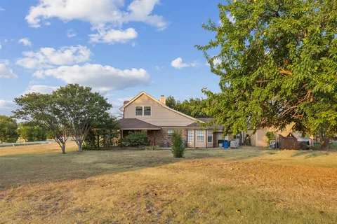 a view of a house with a yard and garage