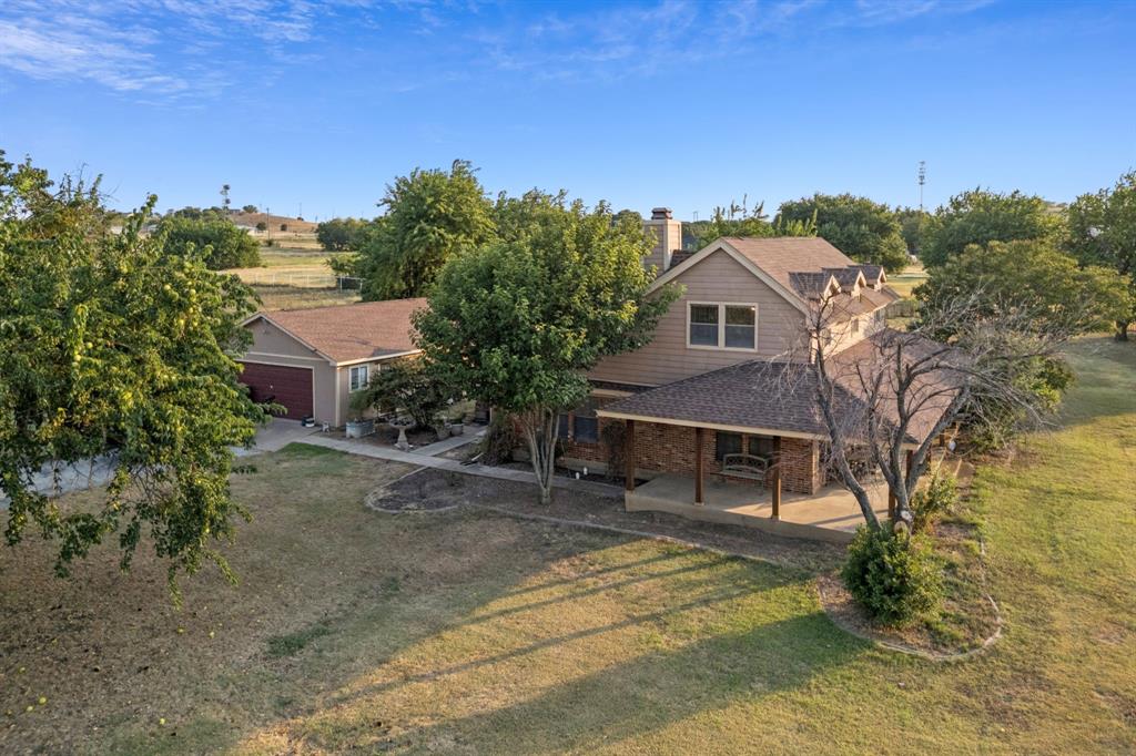 202 Blue Mound Road East Haslet, TX 76052 - Photo 26 of 31 a view of a house with a yard and sitting area