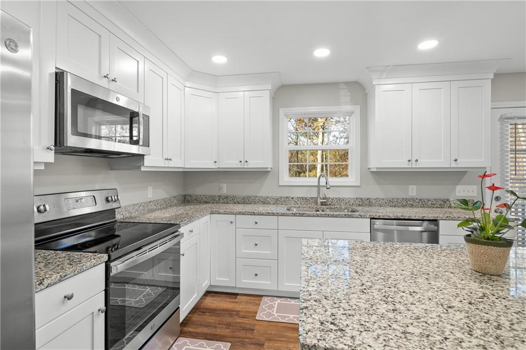 2708 Quarles Road Rocky Face, GA 30740 - Photo 13 of 40 a kitchen with stainless steel appliances granite countertop a stove a sink and a microwave