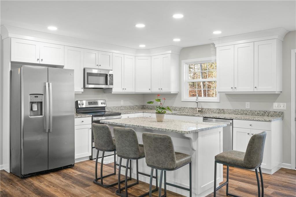 2708 Quarles Road Rocky Face, GA 30740 - Photo 14 of 40 a kitchen with stainless steel appliances granite countertop a refrigerator a stove a sink a dining table and chairs