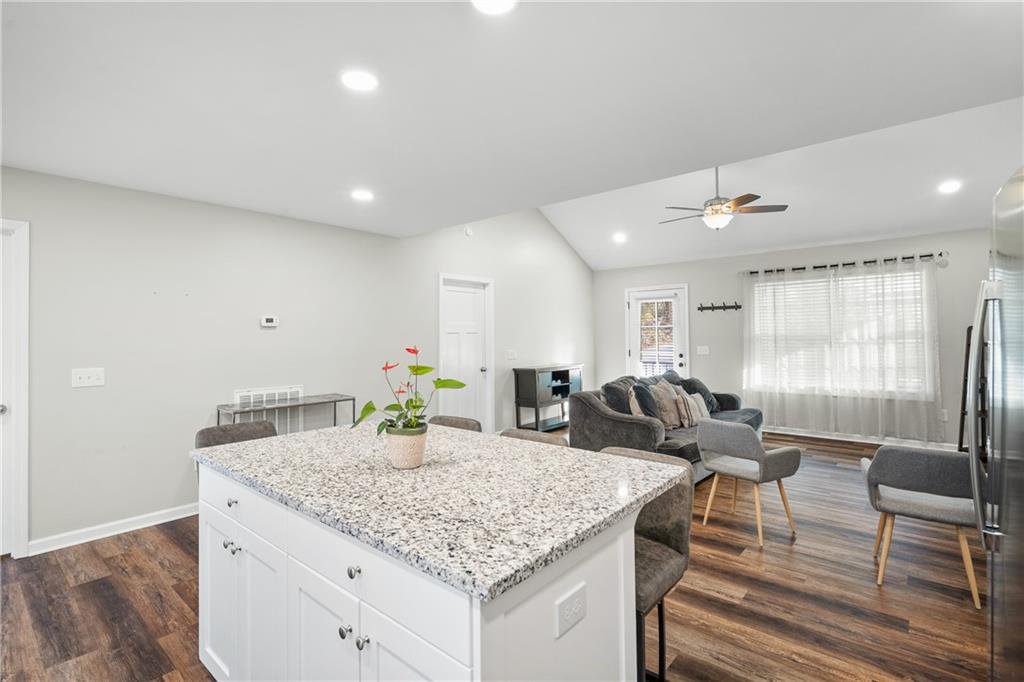 2708 Quarles Road Rocky Face, GA 30740 - Photo 17 of 40 a kitchen with granite countertop kitchen island stainless steel appliances a sink and living room view
