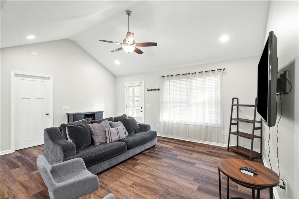 2708 Quarles Road Rocky Face, GA 30740 - Photo 10 of 40 a living room with furniture a ceiling fan and a rug