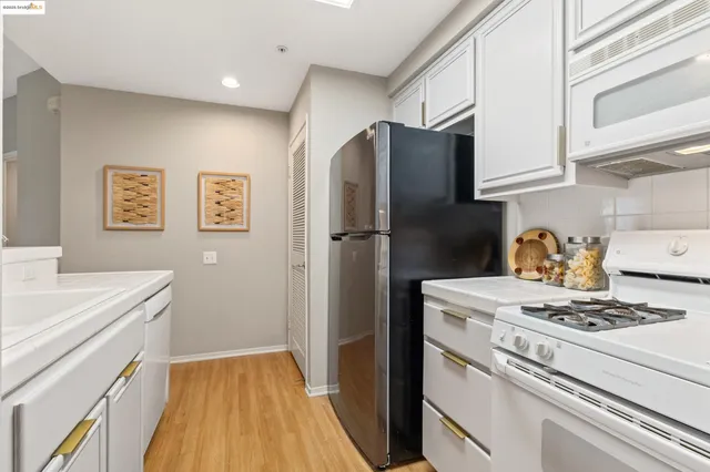 a kitchen with stainless steel appliances a refrigerator and a stove top oven