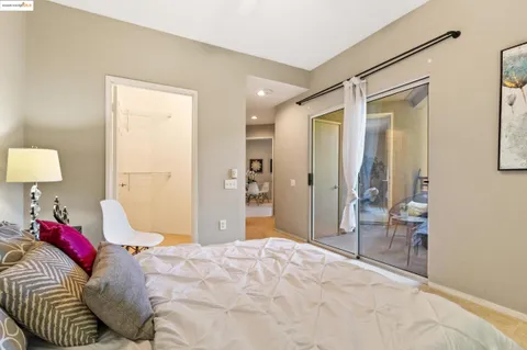 a bedroom with a bed and a lamp