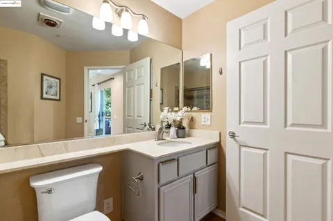a bathroom with a sink vanity and a mirror