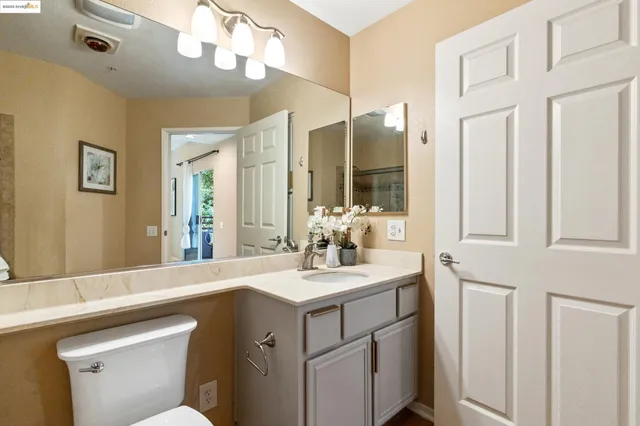 a bathroom with a sink vanity and a mirror