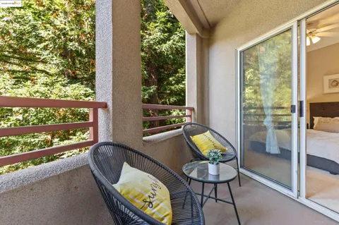a view of a chairs and table in a balcony