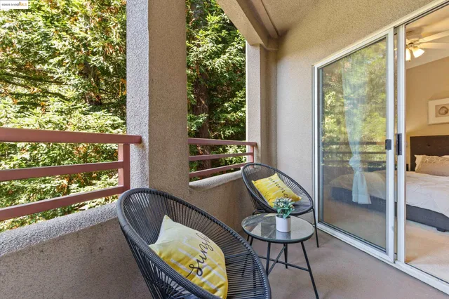 a view of a chairs and table in a balcony