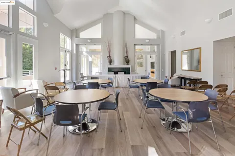 a view of a a dining room with furniture window and wooden floor